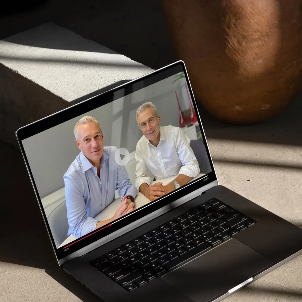 Two men in a video call on a modern laptop screen